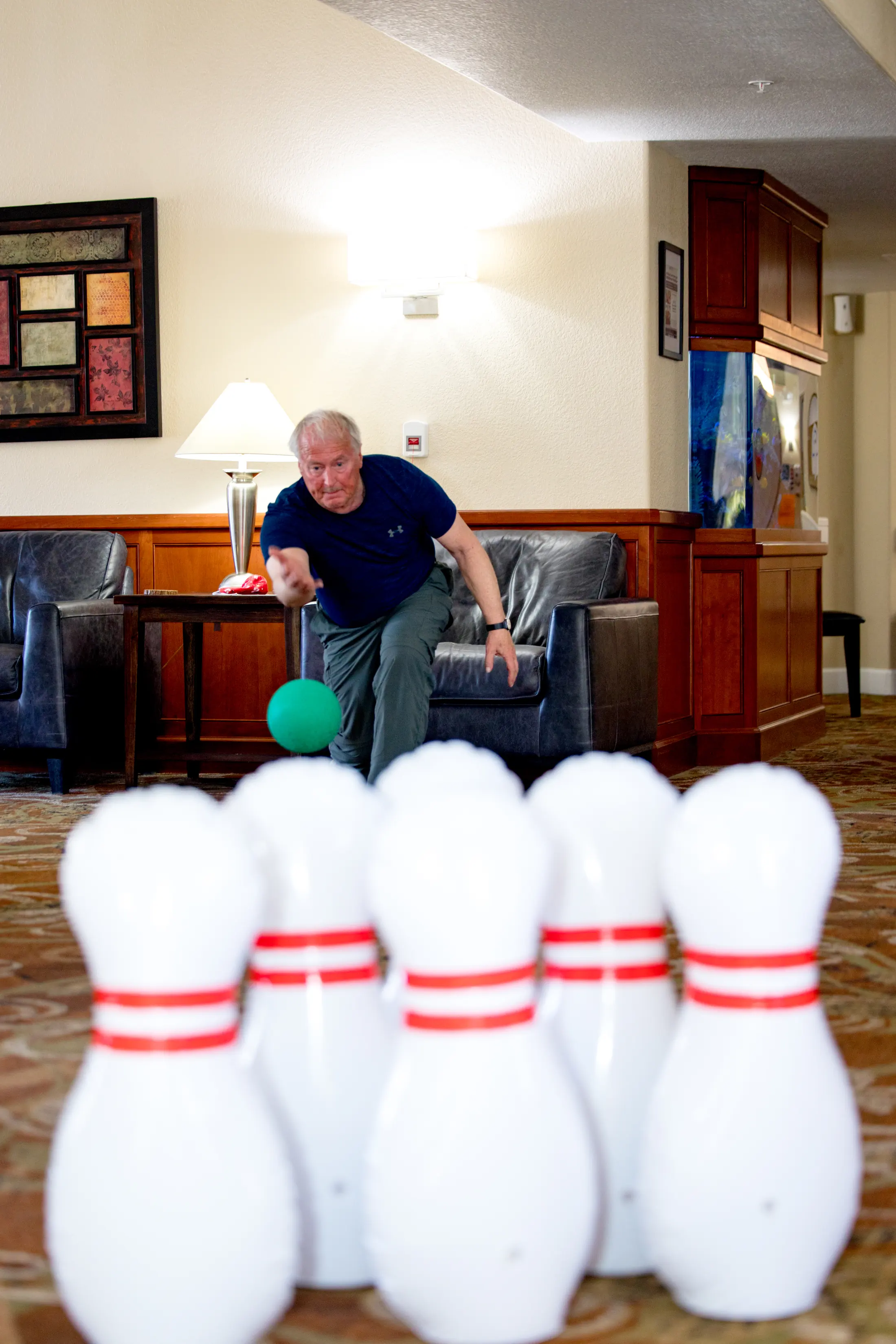 Golden Pond resident playing bowling in a community activity space.
